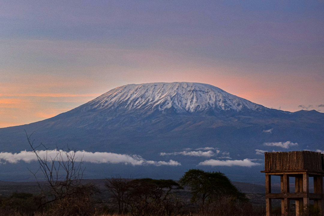 Snow-capped Mount Kilimanjaro rising above the East African savanna at sunrise